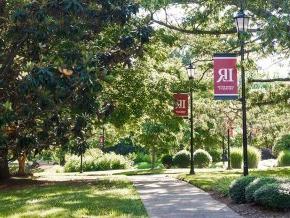 Red LR banners along a campus sidewalk